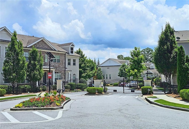 4107 Township Pkwy Unit 69, Sandy Springs, GA 30342 - view of asphalt road with sidewalks, curbs, and a gate