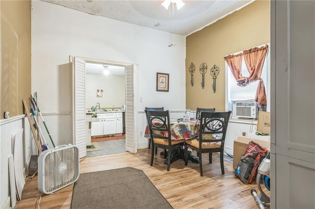 1454 Beecher St SW, Atlanta, GA 30310 - dining area featuring cooling unit, light wood-style floors, and a textured ceiling