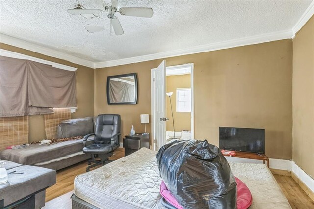 1454 Beecher St SW, Atlanta, GA 30310 - bedroom with wood finished floors, crown molding, a textured ceiling, and a ceiling fan