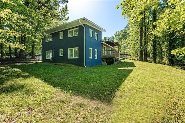 view of side of home featuring a yard and a deck