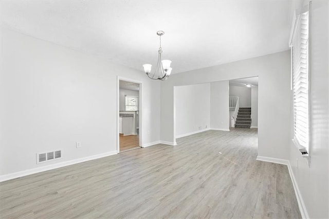 interior space featuring light hardwood / wood-style floors and a notable chandelier