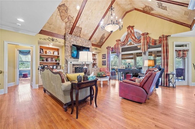 living area featuring built in features, baseboards, high vaulted ceiling, a notable chandelier, and light wood-type flooring