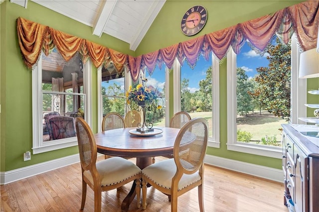 dining room with baseboards, wood ceiling, light wood-style flooring, and vaulted ceiling with beams