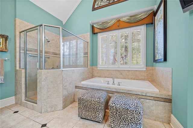 bathroom featuring a bath, tile patterned flooring, a shower stall, and vaulted ceiling