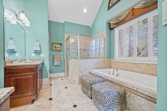 bathroom featuring lofted ceiling, a garden tub, a stall shower, tile patterned floors, and vanity