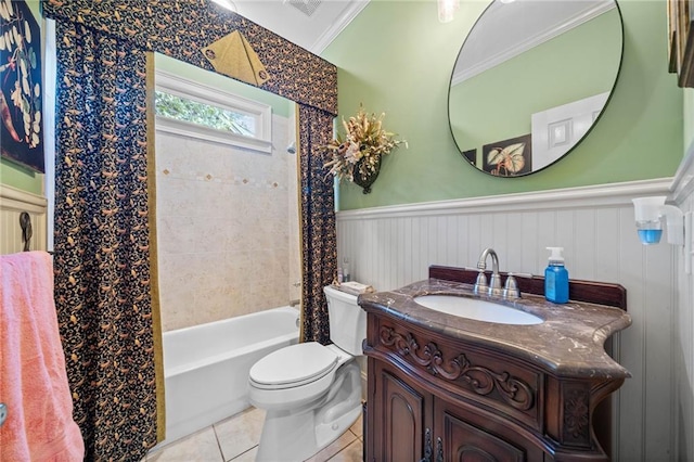 bathroom featuring vanity, a wainscoted wall, shower / bath combo, tile patterned floors, and toilet