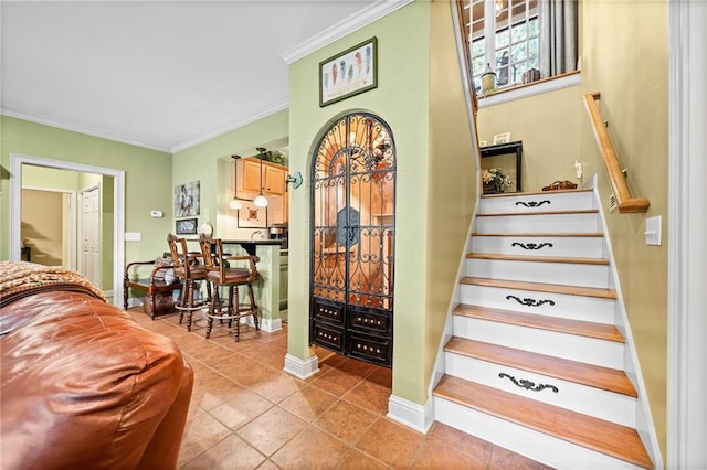 stairway featuring tile patterned flooring, baseboards, and ornamental molding