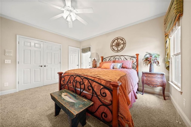 carpeted bedroom featuring a ceiling fan, baseboards, and ornamental molding