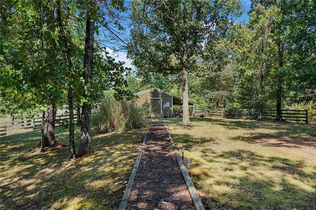 view of yard with an outdoor structure and fence