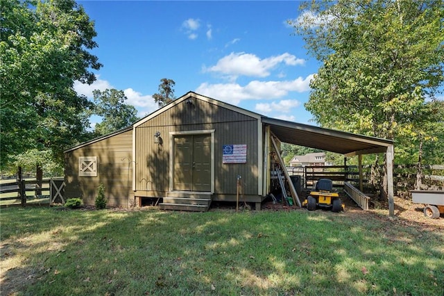 view of outdoor structure with an outbuilding and fence