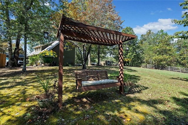 view of yard with a pergola and fence