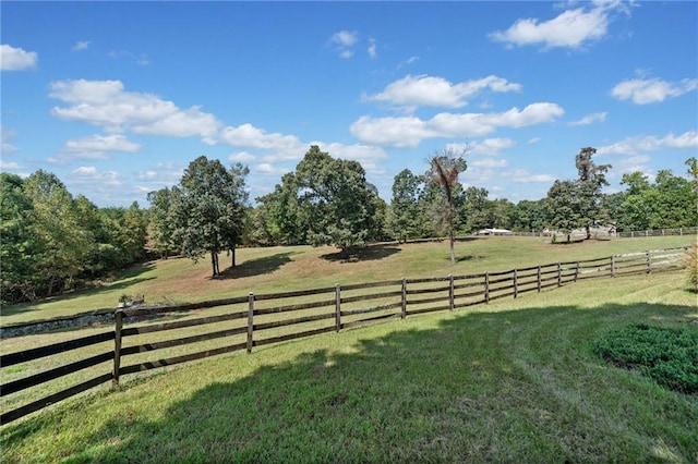 view of yard featuring a rural view and fence