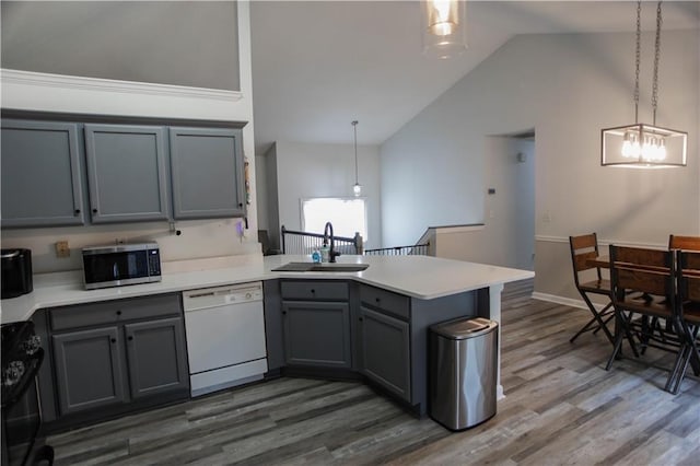 7930 River Fall Ct, Ball Ground, GA 30107 - kitchen featuring dishwasher, stainless steel microwave, gray cabinets, a peninsula, and lofted ceiling