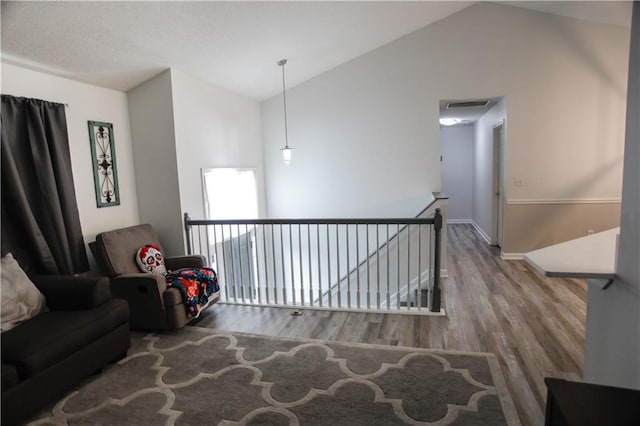 7930 River Fall Ct, Ball Ground, GA 30107 - living area featuring an upstairs landing, vaulted ceiling, and wood finished floors