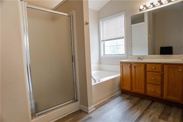 7930 River Fall Ct, Ball Ground, GA 30107 - bathroom with a shower stall, wood finished floors, double vanity, a bath, and lofted ceiling