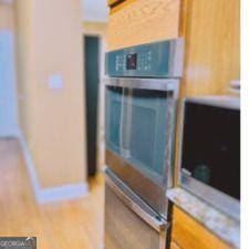 1090 Crown River Pkwy, Mcdonough, GA 30252 - kitchen with double oven, light countertops, and baseboards