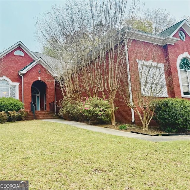 1090 Crown River Pkwy, Mcdonough, GA 30252 - view of front of house with a front lawn and brick siding