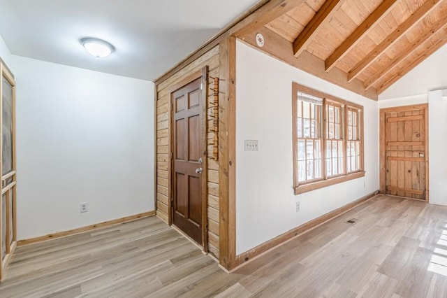 foyer featuring light hardwood / wood-style flooring, wooden ceiling, and lofted ceiling with beams