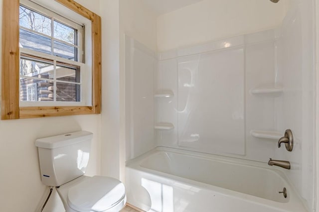 bathroom with toilet and shower / washtub combination