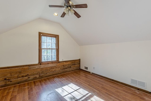 bonus room featuring vaulted ceiling, hardwood / wood-style floors, and ceiling fan