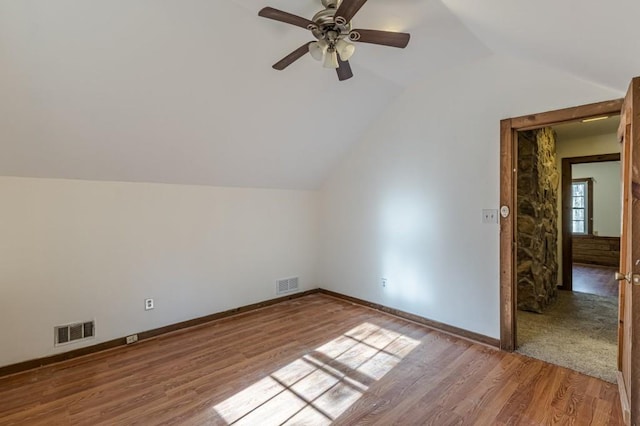 bonus room with lofted ceiling, light wood-type flooring, and ceiling fan