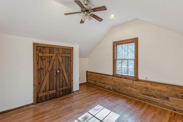 bonus room with vaulted ceiling, ceiling fan, and light hardwood / wood-style floors