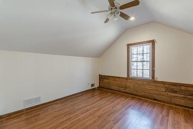 additional living space featuring vaulted ceiling, ceiling fan, and hardwood / wood-style flooring