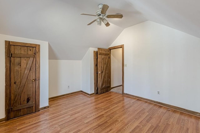 bonus room featuring ceiling fan, light wood-type flooring, and vaulted ceiling