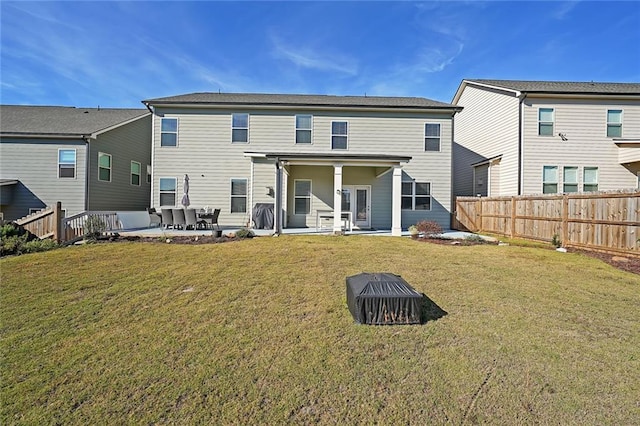 back of house featuring a patio area and a yard