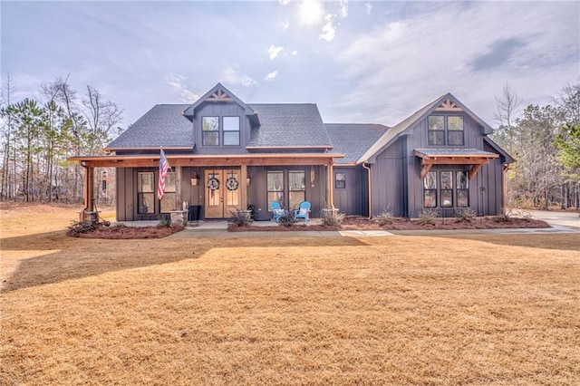 view of front of property with covered porch and a front lawn