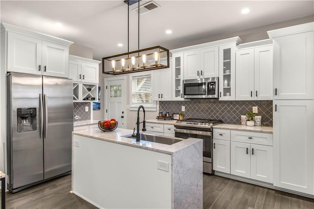 kitchen with pendant lighting, white cabinets, sink, dark hardwood / wood-style floors, and stainless steel appliances