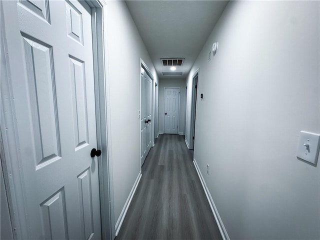 hallway featuring dark hardwood / wood-style flooring