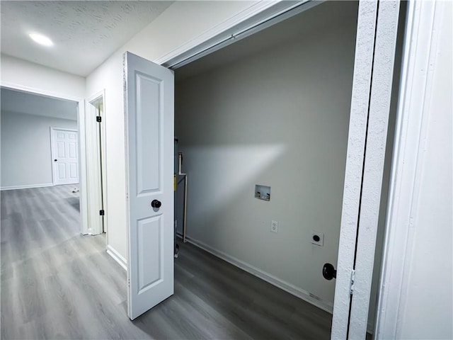 laundry area with hookup for an electric dryer, wood-type flooring, a textured ceiling, and hookup for a washing machine