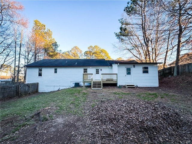 back of house featuring a yard and a deck