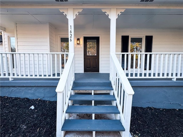 doorway to property featuring covered porch