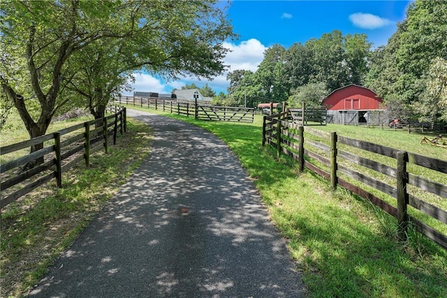 view of road with a rural view and a barn
