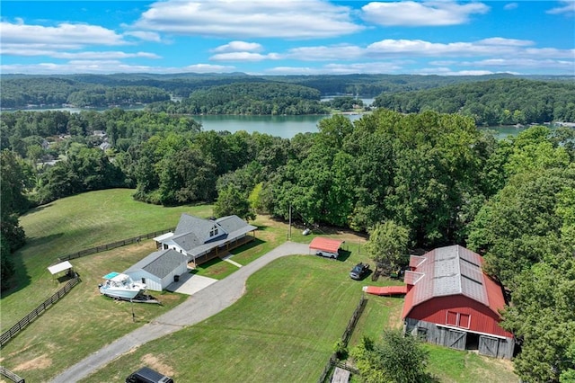 aerial view featuring a water view and a wooded view