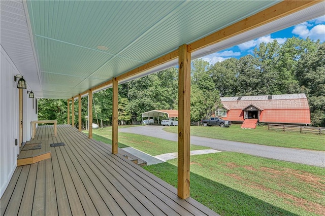 deck with a yard and fence