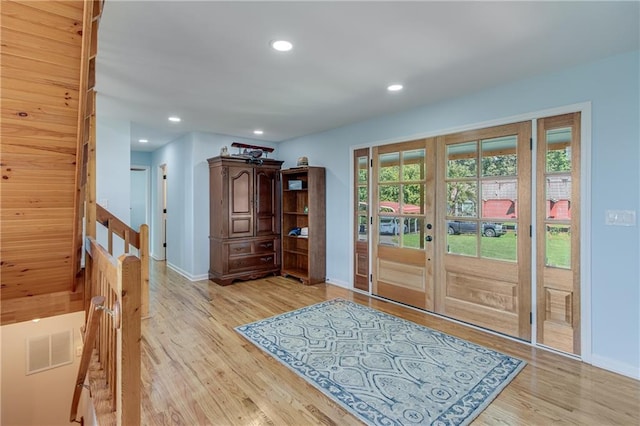 doorway featuring visible vents, light wood finished floors, baseboards, recessed lighting, and french doors