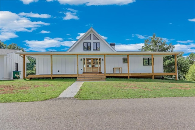 view of front facade with french doors, a chimney, board and batten siding, and a front yard
