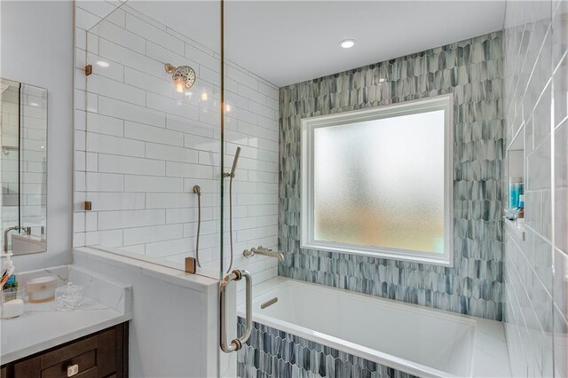 bathroom featuring independent shower and bath and vanity