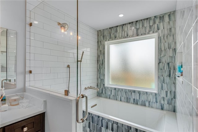 full bathroom with a bathtub, vanity, and a walk in shower