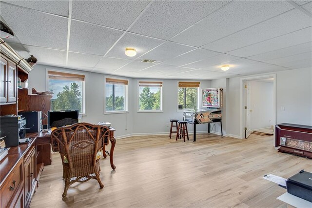 office space featuring light hardwood / wood-style flooring and a paneled ceiling