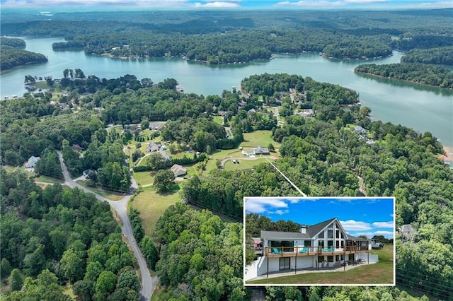 birds eye view of property featuring a view of trees and a water view