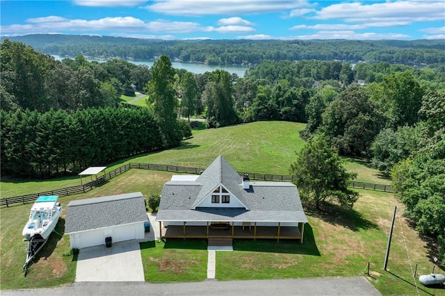 aerial view with a rural view, a forest view, and a water view