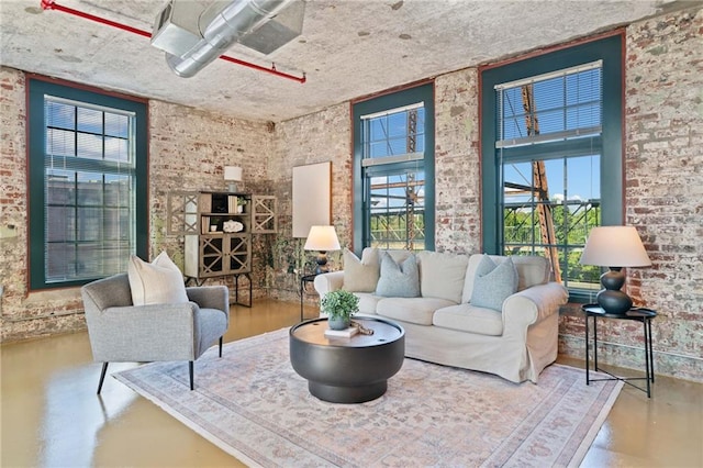 170 Boulevard Se E414, Atlanta, GA 30312 - living area featuring healthy amount of natural light, finished concrete floors, and brick wall