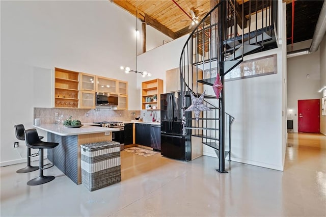 170 Boulevard Se E414, Atlanta, GA 30312 - kitchen with a towering ceiling, appliances with stainless steel finishes, open shelves, tasteful backsplash, and concrete flooring