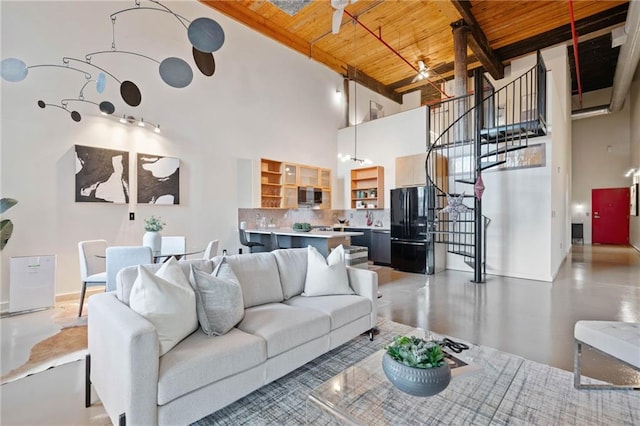170 Boulevard Se E414, Atlanta, GA 30312 - living room featuring wood ceiling with exposed beams, a high ceiling, and stairs