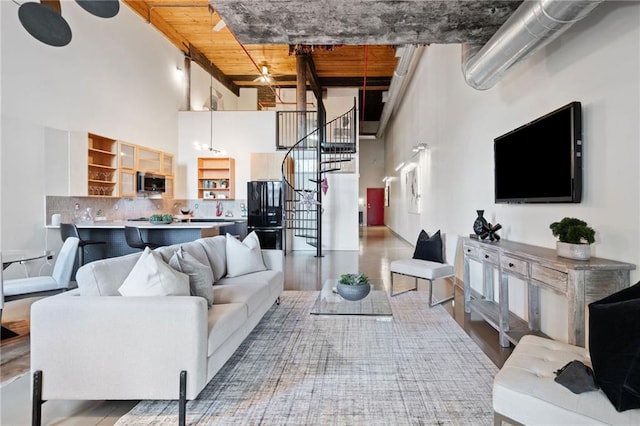 170 Boulevard Se E414, Atlanta, GA 30312 - living room featuring a high ceiling, wood finished floors, and stairs