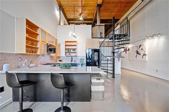 170 Boulevard Se E414, Atlanta, GA 30312 - kitchen featuring black refrigerator, open shelves, wooden ceiling, finished concrete floors, and a peninsula